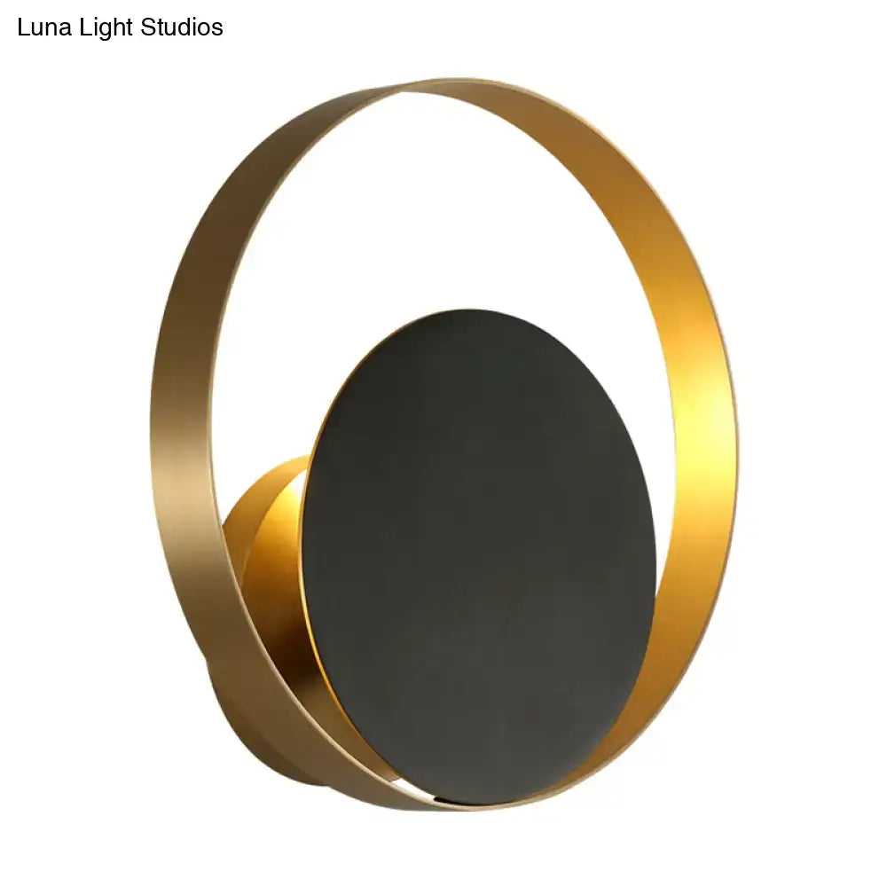 Black brass circular sconce with gold ring and dark center on Tampa Home & Garden Store