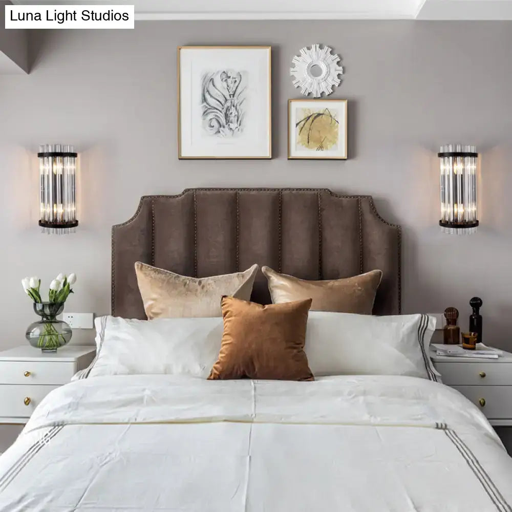 Decorbites Black Gold Rod Wall Sconce pair with cylindrical glass tubes flanking the bed on Tampa Home & Garden Store