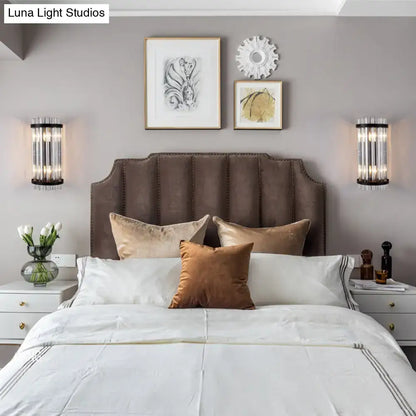 Decorbites Black Gold Rod Wall Sconce pair with cylindrical glass tubes flanking the bed on Tampa Home & Garden Store