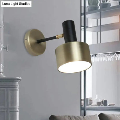 Modern black and brass cylinder wall sconce with gold shade and black arm Decorbites on Tampa Home & Garden Store