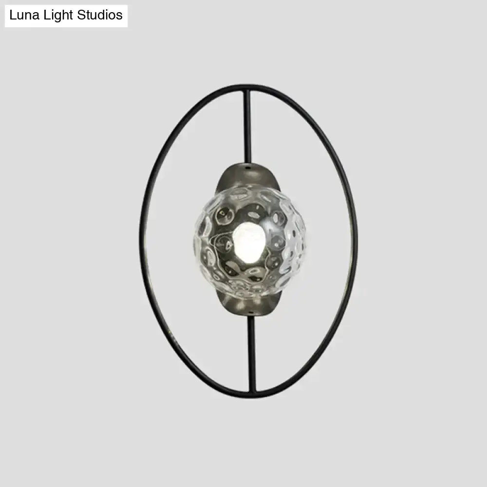 Modern black & gold glass orb wall lamp with circular metal ring and textured globe on Tampa Home & Garden Store