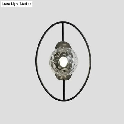 Modern black & gold glass orb wall lamp with circular metal ring and textured globe on Tampa Home & Garden Store