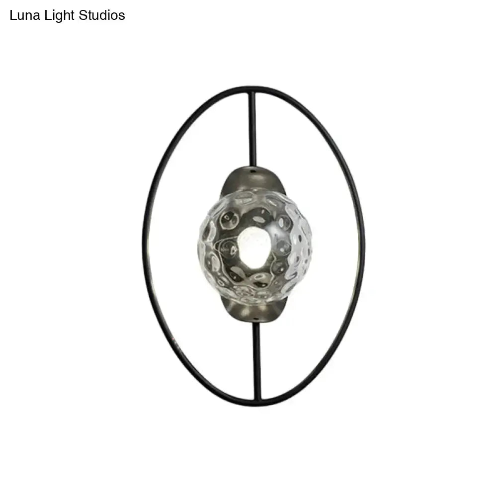 Modern black and gold glass orb wall lamp with circular metal frame for bedroom on Tampa Home & Garden Store