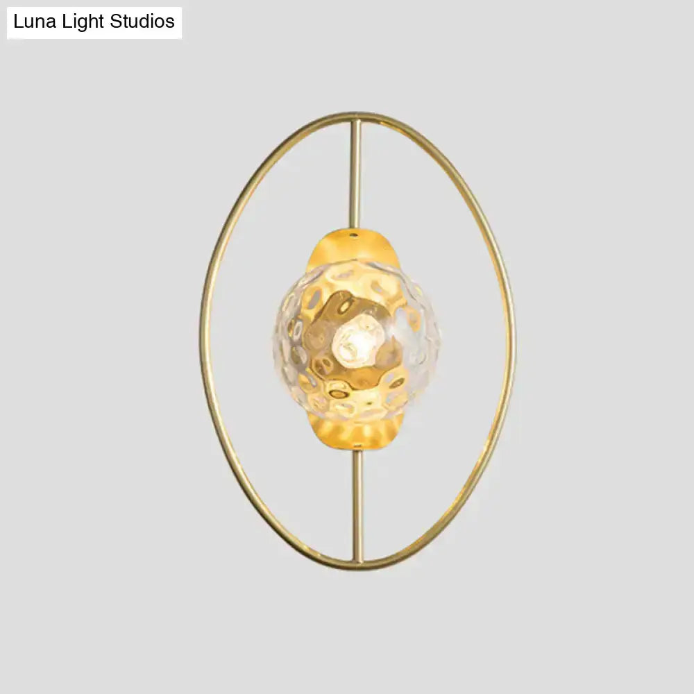 Modern gold glass orb wall lamp with circular brass ring and hammered glass orb bulb Decorbites on Tampa Home & Garden Store