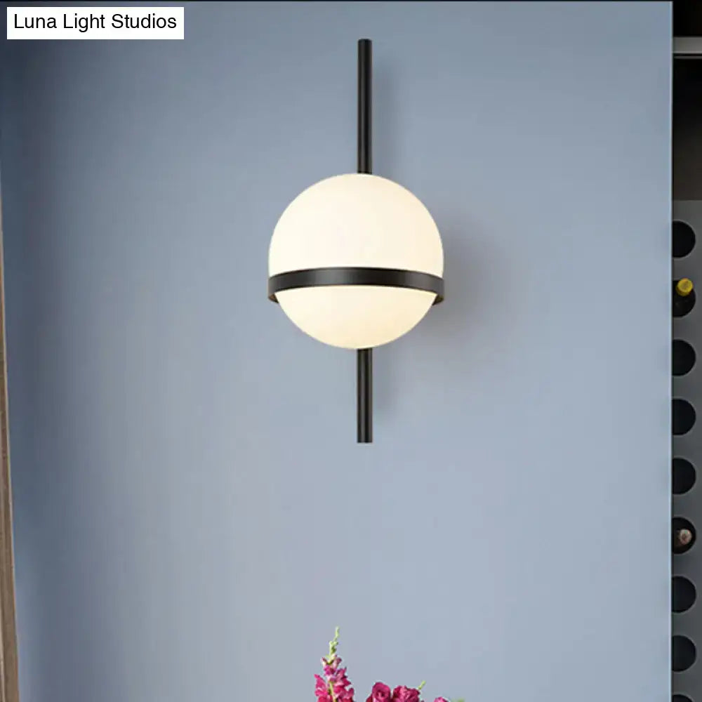 Black Gold Glass Sconce with frosted globe and black metal band on a vertical rod on Tampa Home & Garden Store