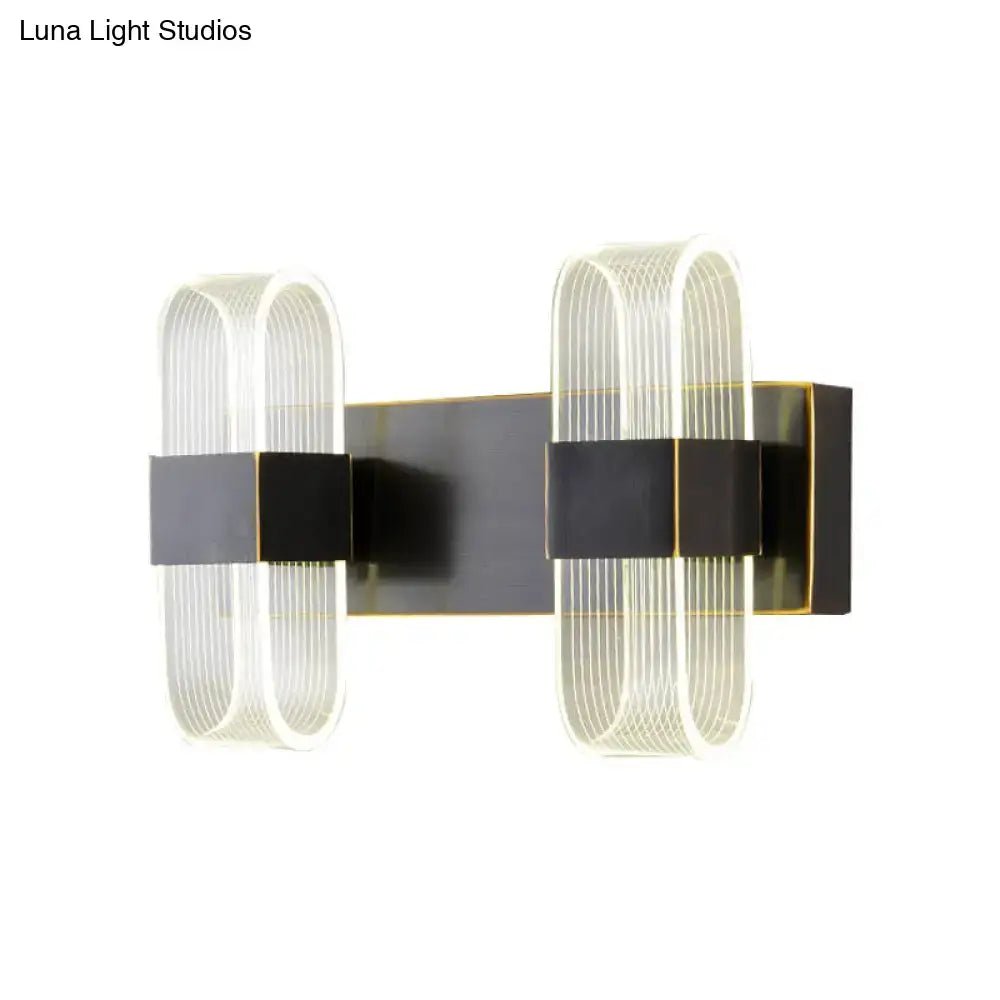 Black oval LED wall sconce 1-2 light with ribbed glass loops, black backplate, brass trim on Tampa Home & Garden Store