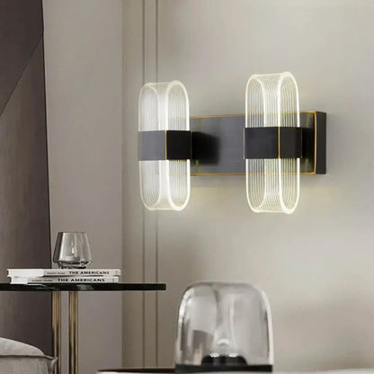Decorbites black oval LED wall sconce 1-2 light with ribbed glass shields on dark metal mount on Tampa Home & Garden Store