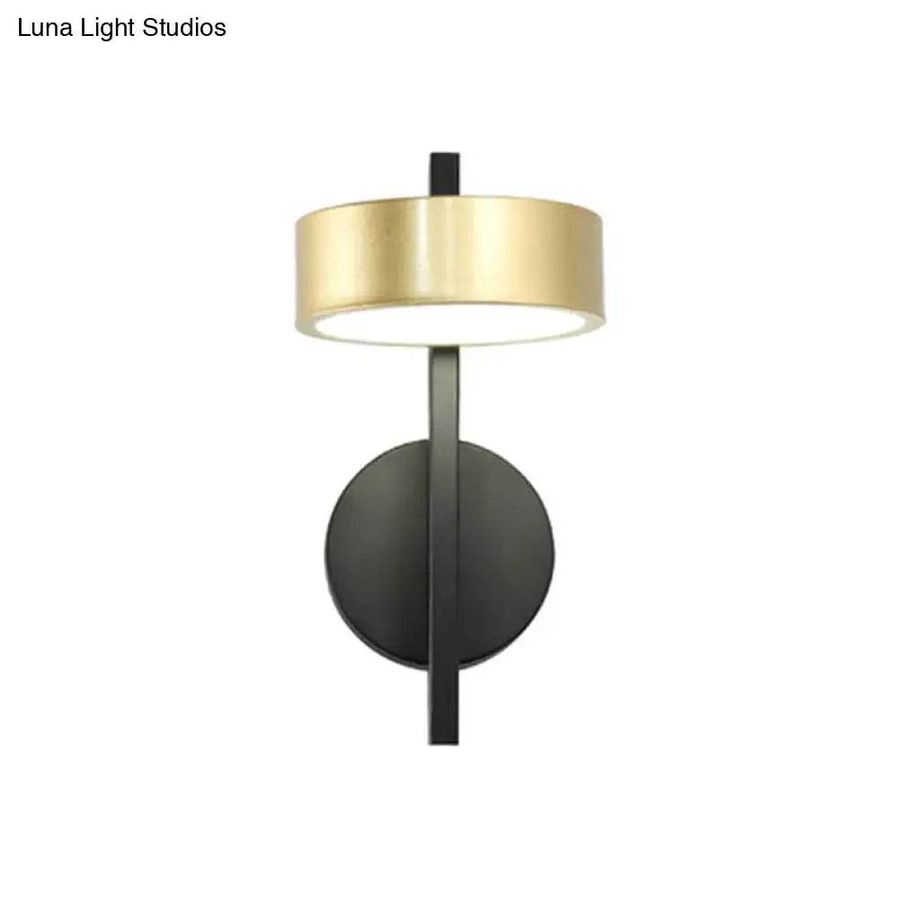 Gold cylinder wall light with black backplate and gold shade on Tampa Home & Garden Store
