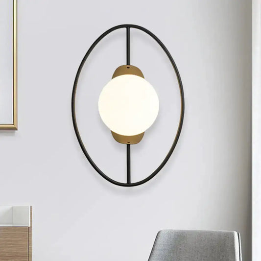 Modern halo ring wall lamp in black metal with gold accents and white glass globe on Tampa Home & Garden Store