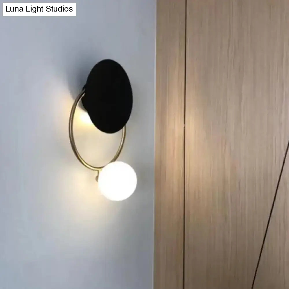 Black Planet Wall Sconce by Decorbites with brass ring and white globe on Tampa Home & Garden Store