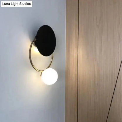 Black Planet Wall Sconce by Decorbites with brass ring and white globe on Tampa Home & Garden Store