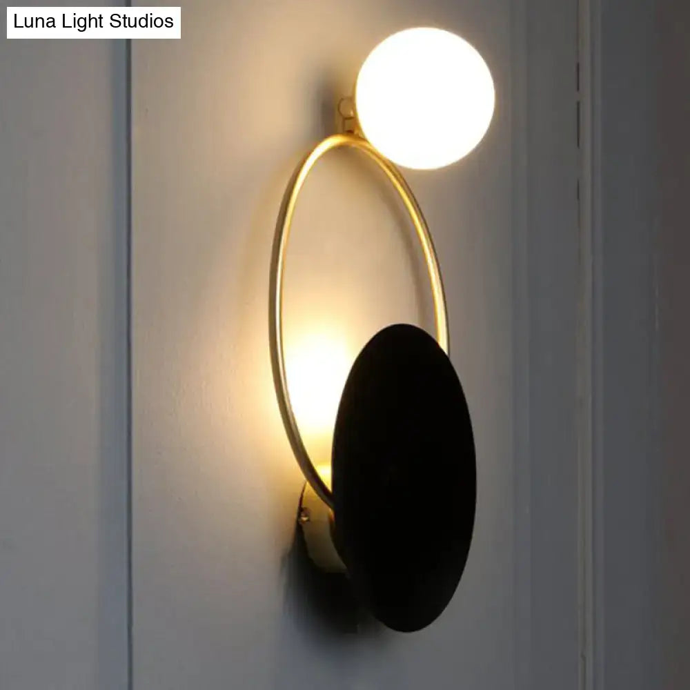 Black Planet Wall Sconce by Decorbites with gold ring and black disk on wall on Tampa Home & Garden Store