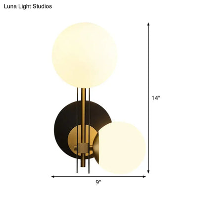 Black Gold Wired Glass Light by Decorbites; brass and black wall sconce with two frosted globes on Tampa Home & Garden Store