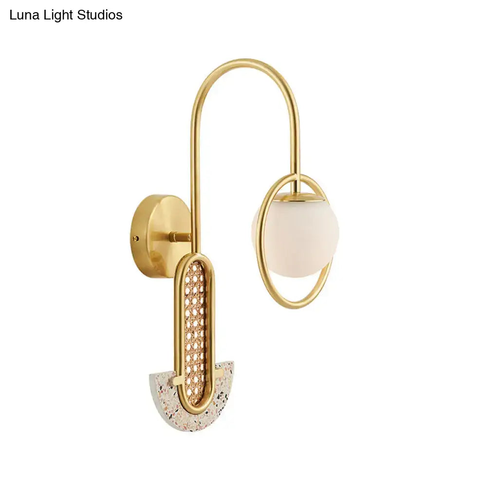 Gold black opal glass sconce with curved brass frame and orb shade Decorbites on Tampa Home & Garden Store