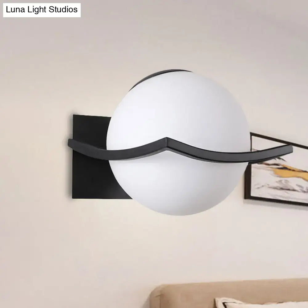 Gold Opal Globe Sconce with frosted white globe and black curved arm on Tampa Home & Garden Store