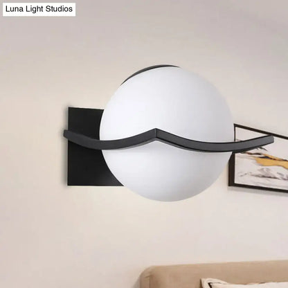 Gold Opal Globe Sconce with frosted white globe and black curved arm on Tampa Home & Garden Store