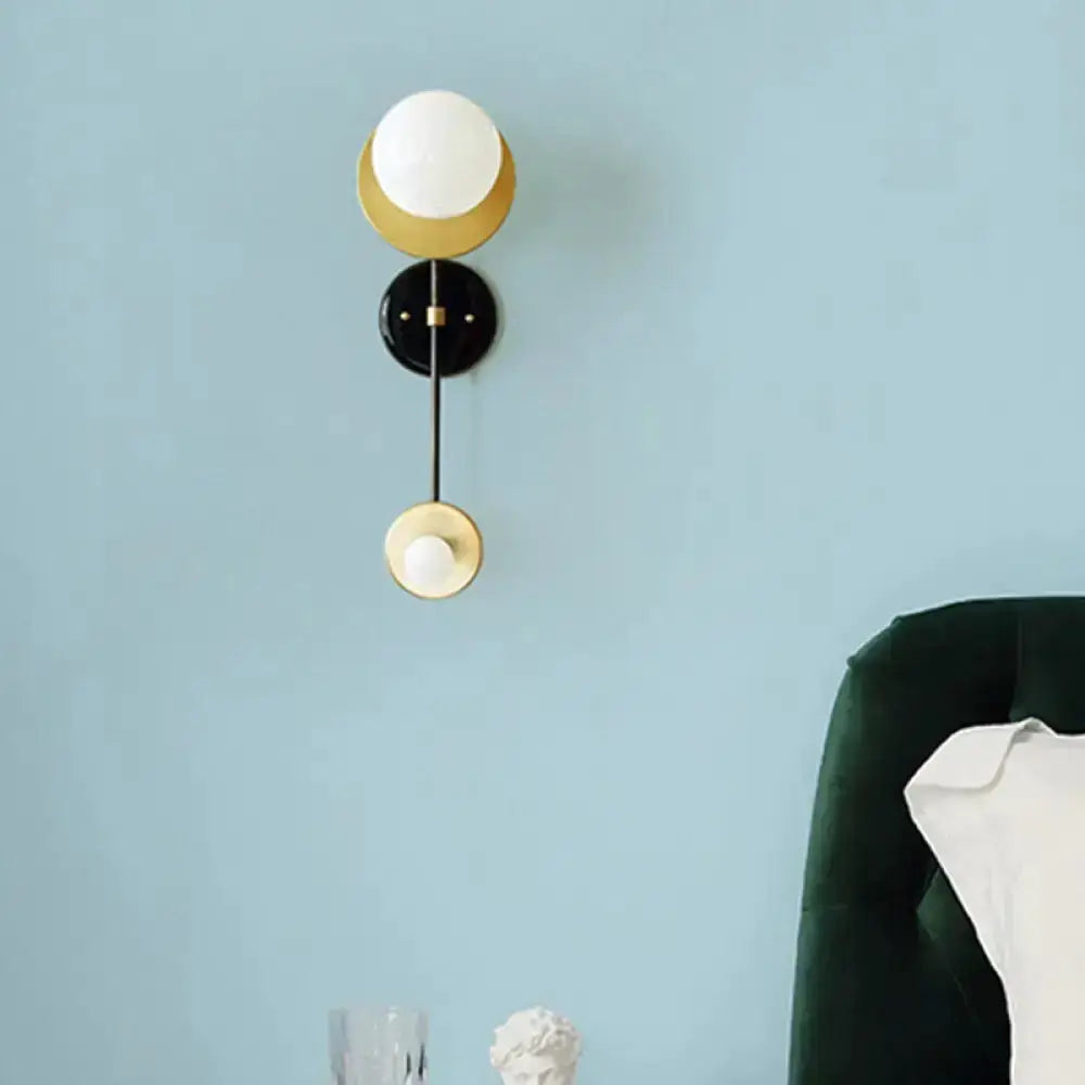 Wall sconce Modern black and gold opal glass globe with brass accents by Decorbites on Tampa Home & Garden Store