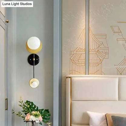 Modern black and gold opal glass wall sconce by Decorbites with two globe shades brass accents on Tampa Home & Garden Store