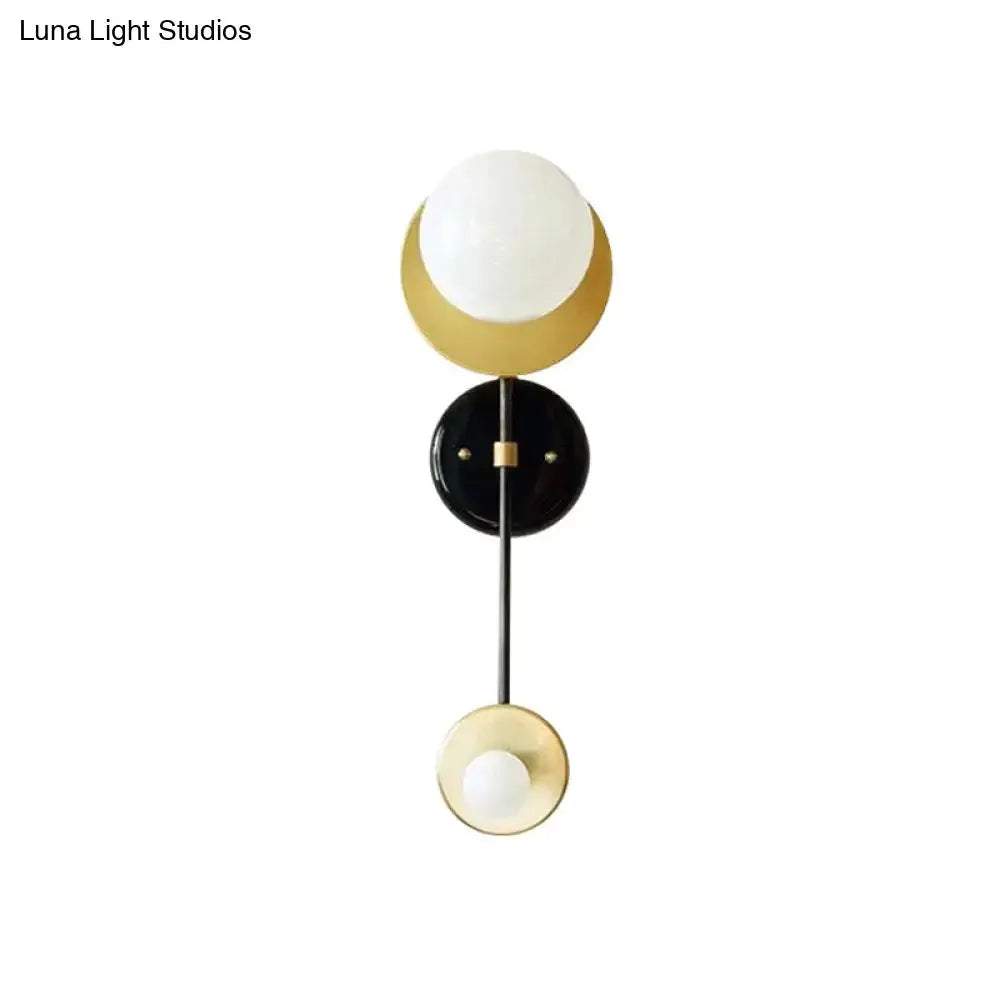 Opal glass wall sconce with black backplate and gold accents by Decorbites on Tampa Home & Garden Store