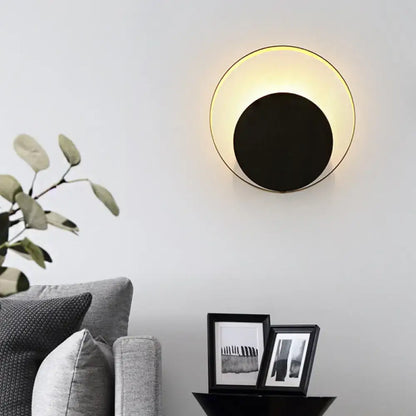 Gold Orbit Sconce Light wall fixture with black center and warm glow by Decorbites on Tampa Home & Garden Store