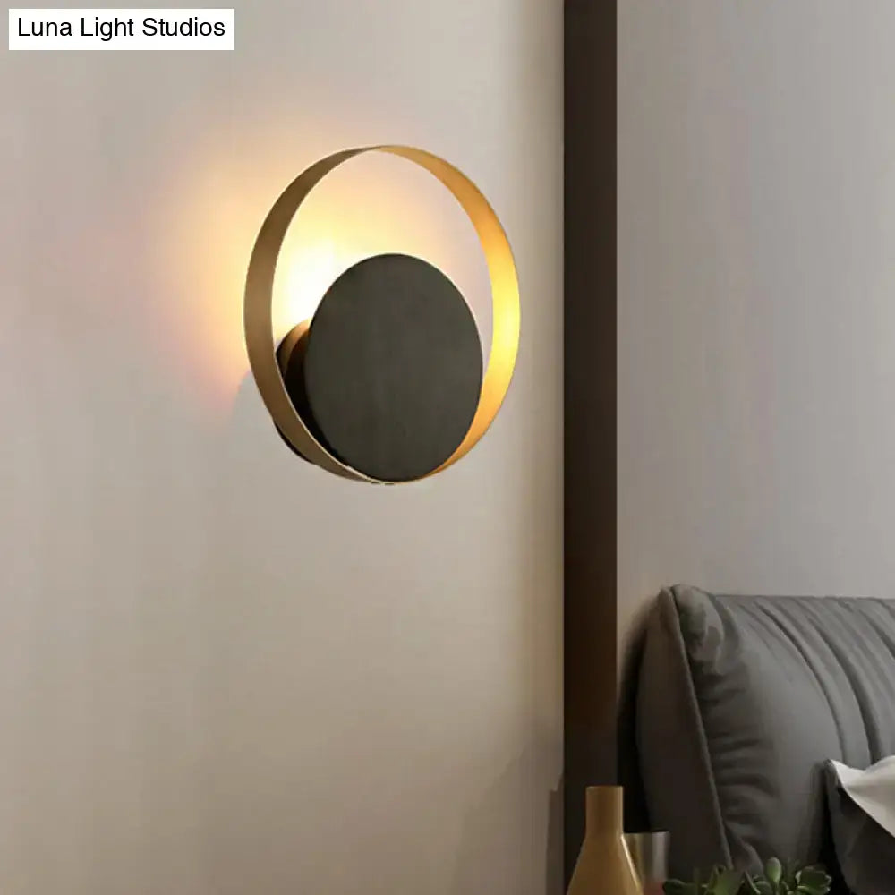 Gold Orbit Sconce Light with gold ring and black backplate, wall-mounted on Tampa Home & Garden Store