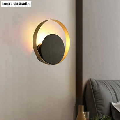 Gold Orbit Sconce Light with gold ring and black backplate, wall-mounted on Tampa Home & Garden Store
