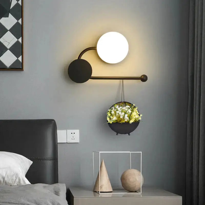 Modern black planter sconce with hanging flower pot and white globe light on Tampa Home & Garden Store