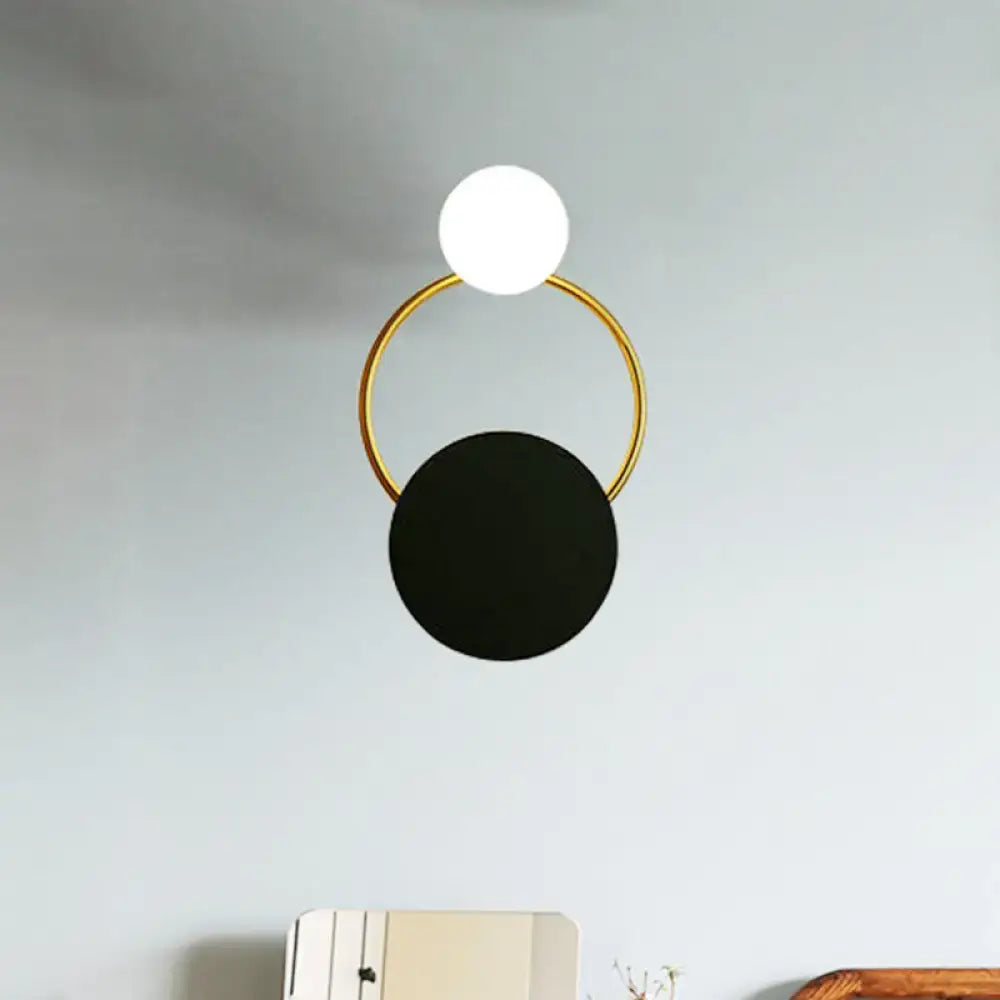 Decorbites black gold round glass sconce with white globe atop black disc on gold ring on Tampa Home & Garden Store