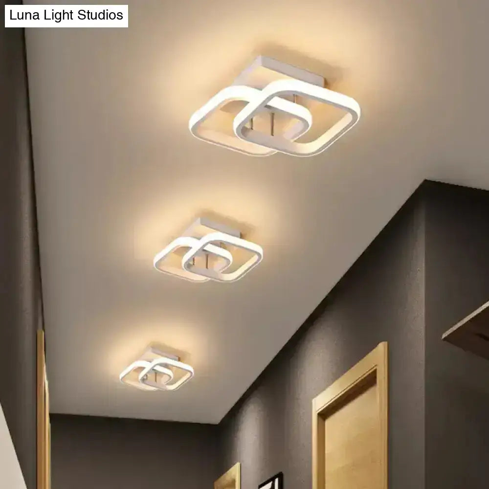 Black Gold Spiral Lamp ceiling light fixture; white square-ring LED trio lighting a hallway on Tampa Home & Garden Store