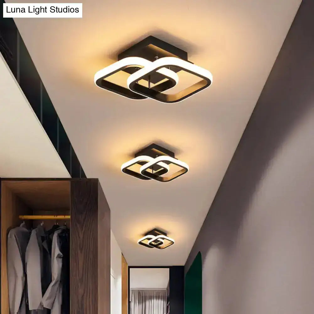 Three black gold spiral ceiling lamps with interlocking loops in a modern hallway on Tampa Home & Garden Store