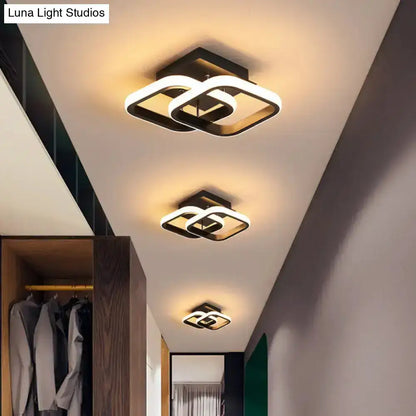 Three black gold spiral ceiling lamps with interlocking loops in a modern hallway on Tampa Home & Garden Store