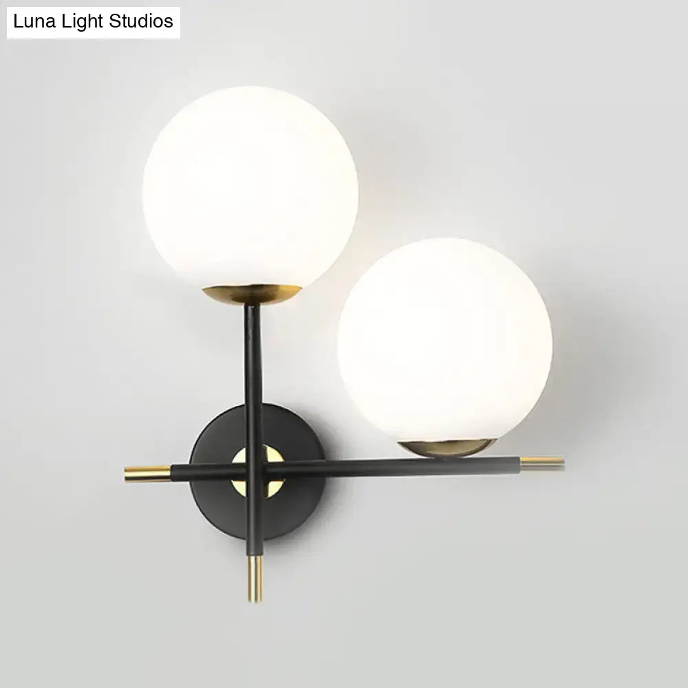 Black milky glass double-globe wall sconce with brass accents Decorbites on Tampa Home & Garden Store