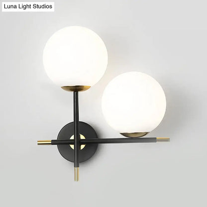Black milky glass double-globe wall sconce with brass accents Decorbites on Tampa Home & Garden Store