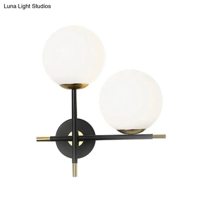 Black Milky Glass Sconce with two frosted globes, black metal frame, brass accents on Tampa Home & Garden Store