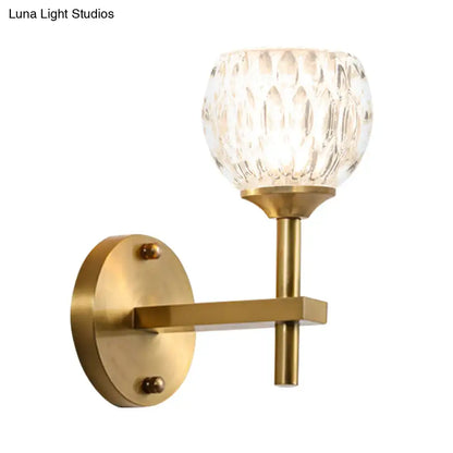 Decorbites gold dimpled glass sconce with brass backplate and horizontal arm, single light on Tampa Home & Garden Store