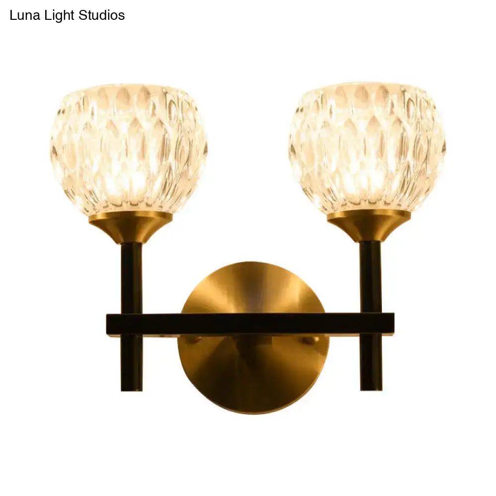 Gold dimpled glass sconce by Decorbites, two glass shades with brass backplate and black arms on Tampa Home & Garden Store