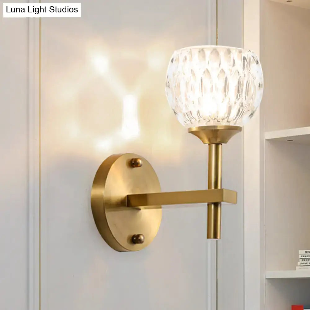 Gold dimpled glass wall sconce with brass backplate and arm on Tampa Home & Garden Store