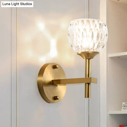 Gold dimpled glass wall sconce with brass backplate and arm on Tampa Home & Garden Store