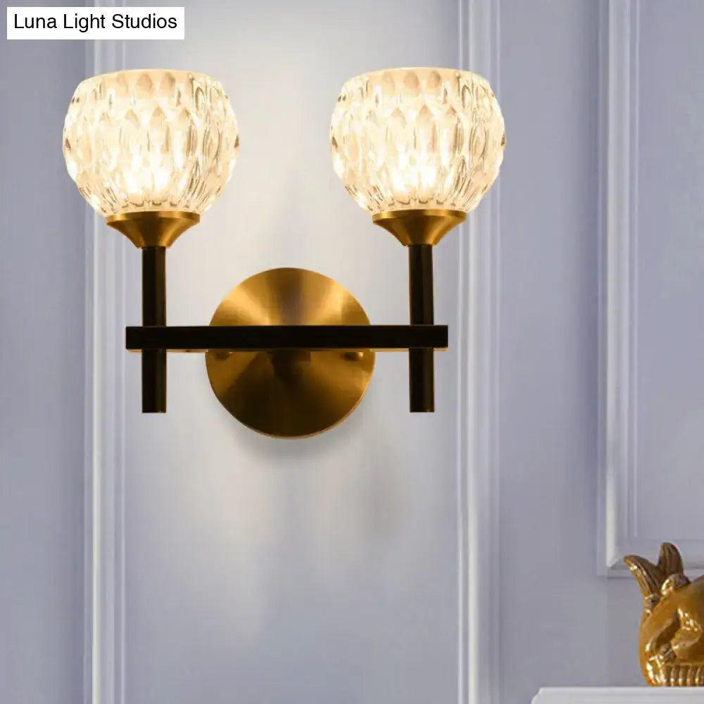 Gold dimpled glass dual-globe sconce with brass arms and round backplate on Tampa Home & Garden Store