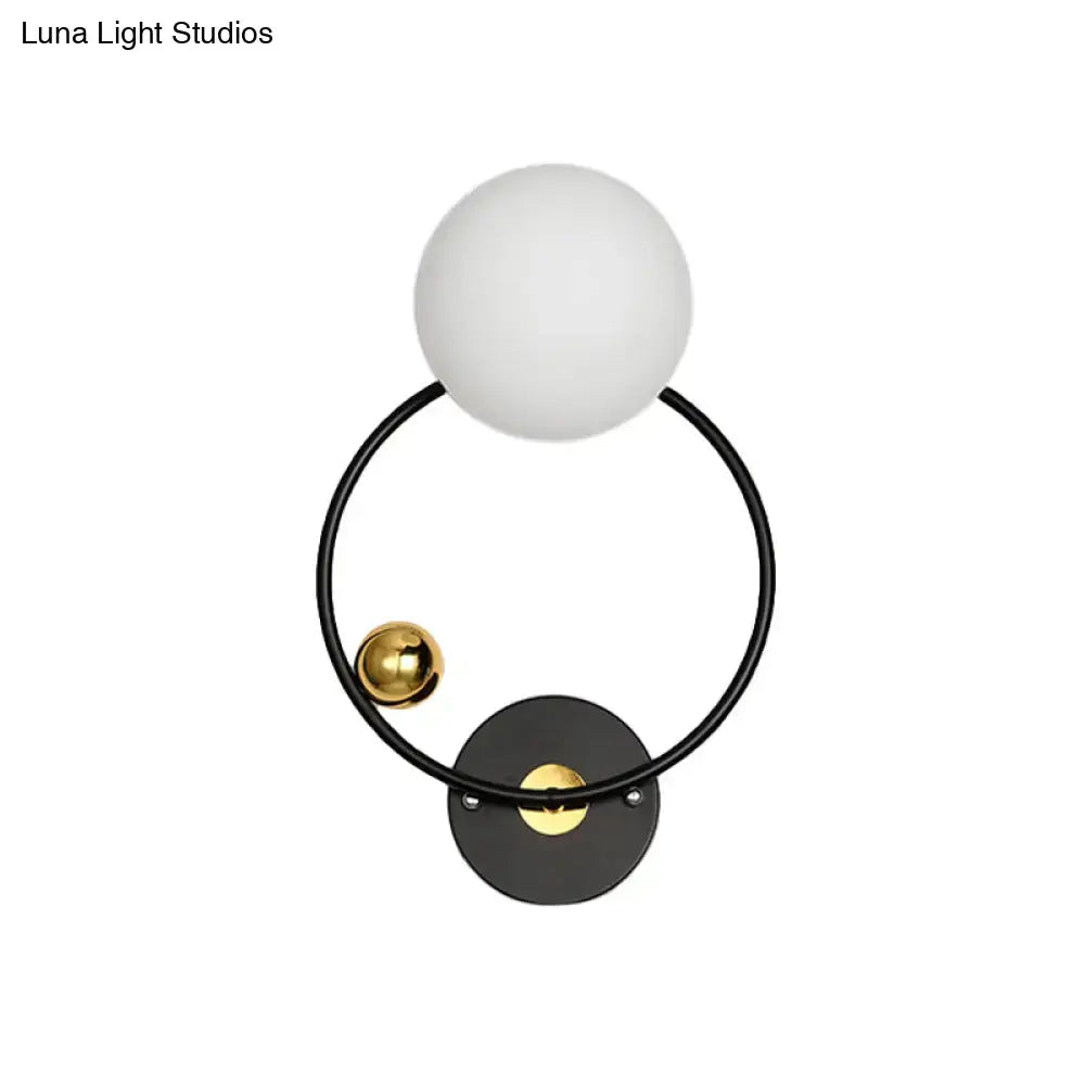 Opal Glass Circular Wall Sconce by Decorbites; frosted globe on black ring with brass accents on Tampa Home & Garden Store