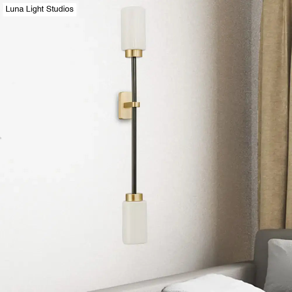 Gold glass wall sconce dual-head tube shade by Decorbites with white shades on black stem on Tampa Home & Garden Store