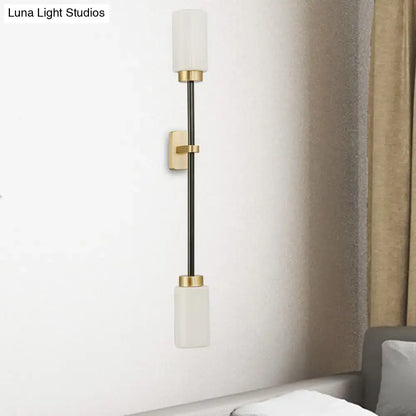 Gold glass wall sconce dual-head tube shade by Decorbites with white shades on black stem on Tampa Home & Garden Store