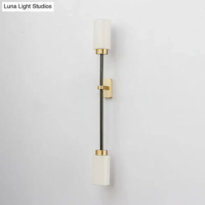 Gold glass wall sconce dual-head with white shades on a slim black stem and gold mounts on Tampa Home & Garden Store
