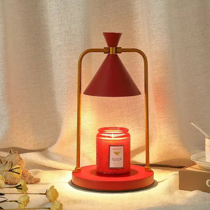 Modern candle warmer lamp with gold frame and red cone shade atop red base Decorbites on Tampa Home & Garden Store