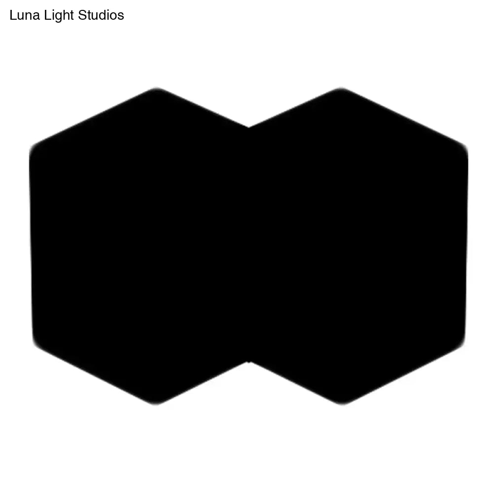 Black hexagon wall sconce with dual-hex silhouette for modern decor on Tampa Home & Garden Store