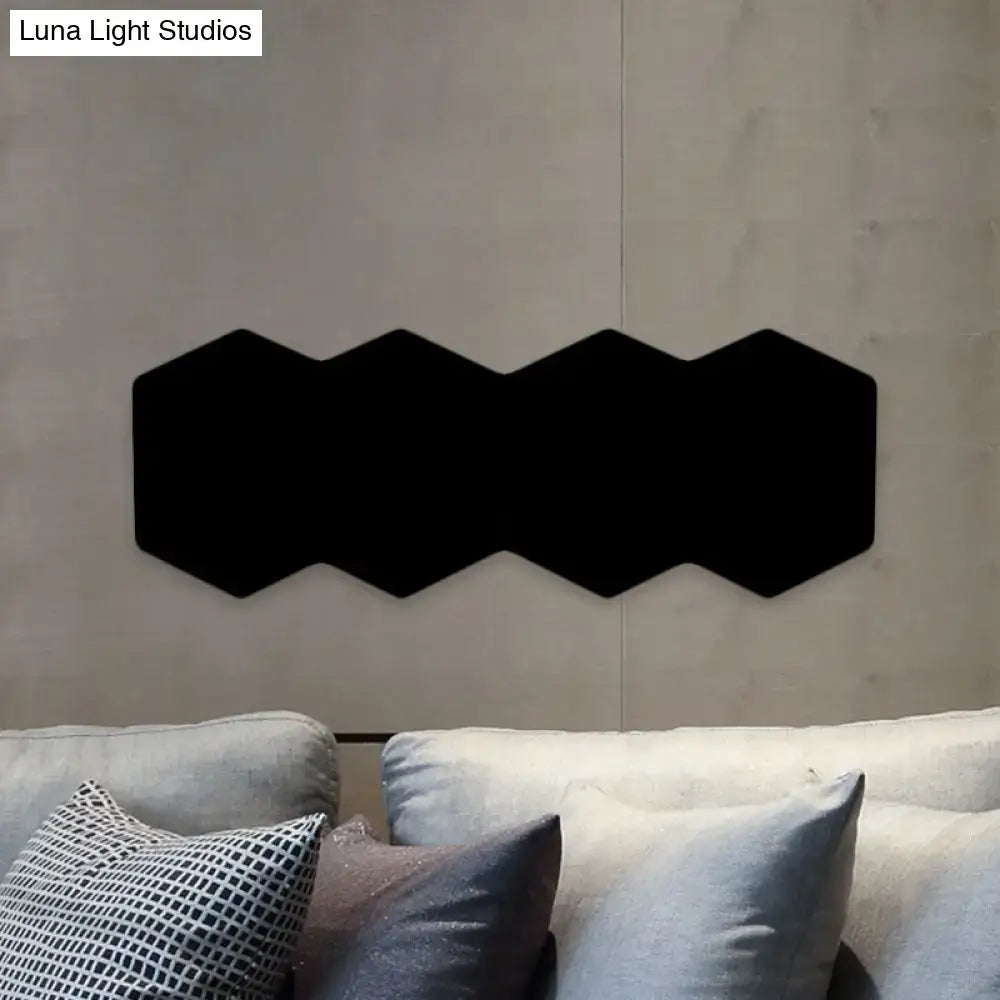 Black hexagon wall sconce by Decorbites, triple-linked matte black panels on gray wall on Tampa Home & Garden Store