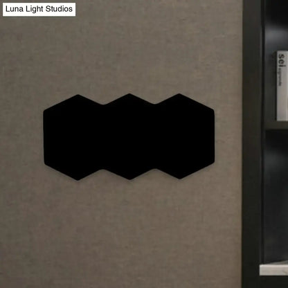 Black Hexagon Wall Sconce by Decorbites with linked hex panels mounted on wall on Tampa Home & Garden Store