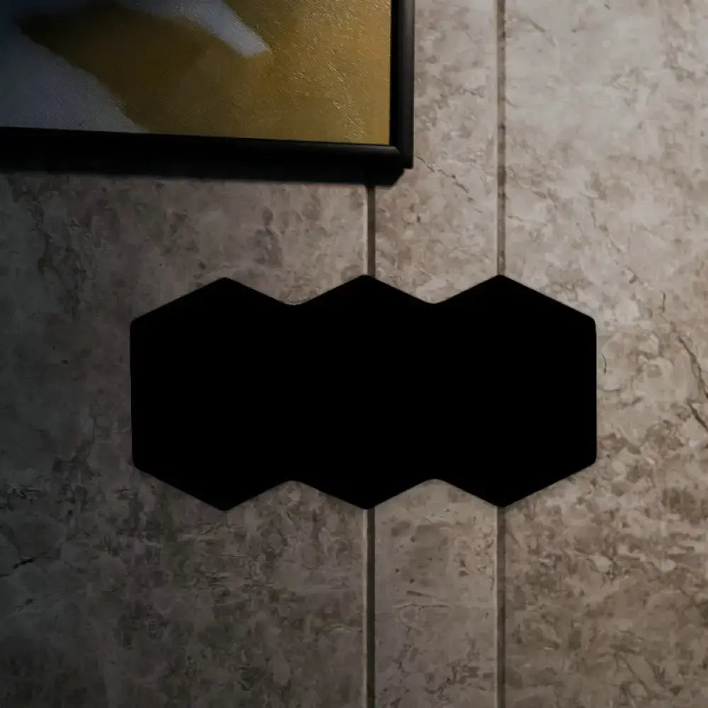 Black hexagon wall sconce on tile wall on Tampa Home & Garden Store