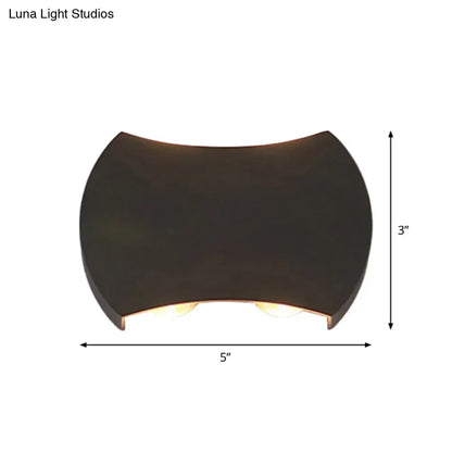 Black LED Wall Washer Decorbites, curved black fixture with warm glow, 5 in wide by 3 in high on Tampa Home & Garden Store