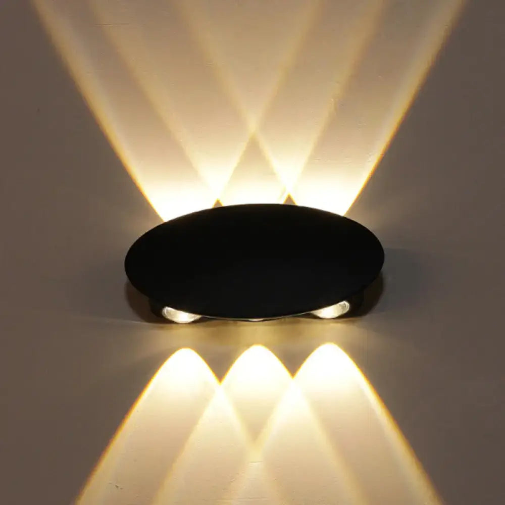 Decorbites Black LED Wall Washer; round black wall-mounted fixture with warm beams on Tampa Home & Garden Store